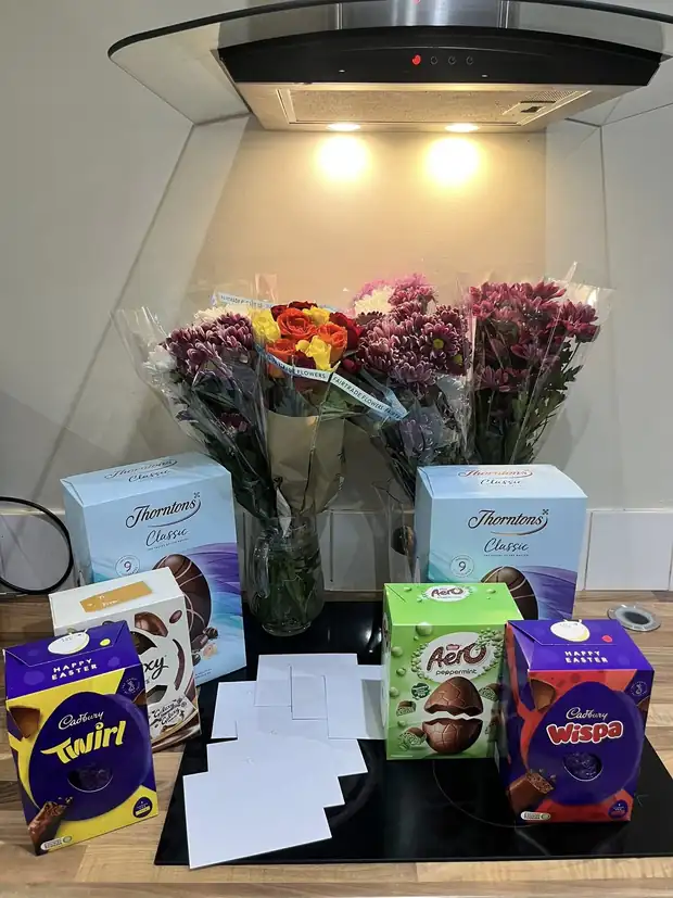Easter eggs and flowers arranged on a kitchen counter